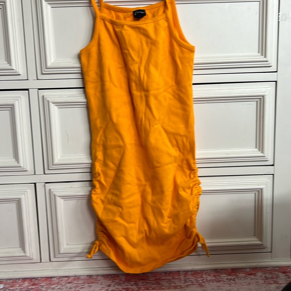 Very cute orange dress would look cute for a little casual dinner somewhere hot.